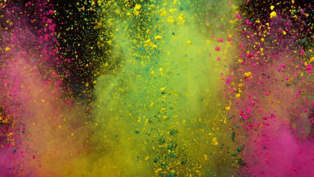 Super slowmotion shot of color powder explosion isolated on black background.