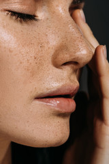 close up view of tender woman with freckles on face isolated on grey - obrazy, fototapety, plakaty
