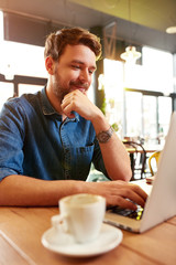 Man work on laptop in cafe