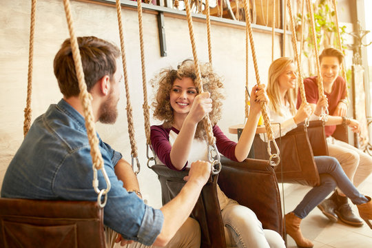 Two Couple Enjoying On Swing