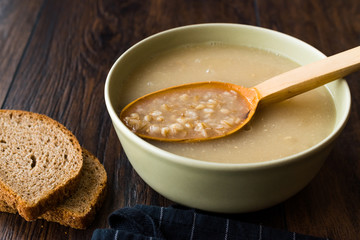 Wheat Soup with Chicken Broth Bouillon on Dark Wooden Surface.