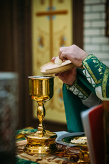 the priest holds the Cup for communion