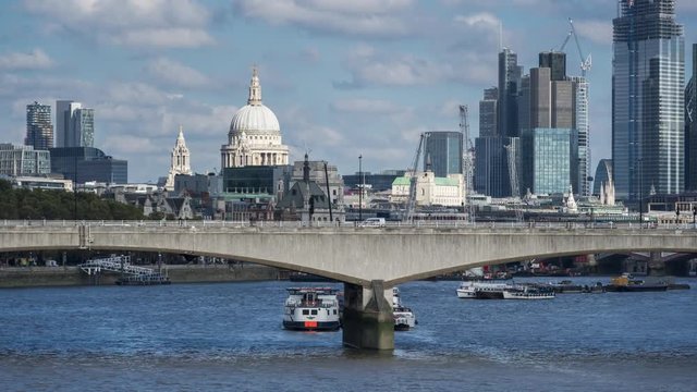 Skyscrapers of The City of London, St.Paul's cathedral, car traffic on Waterloo Bridge, sunny day. Time lapse. London, UK.