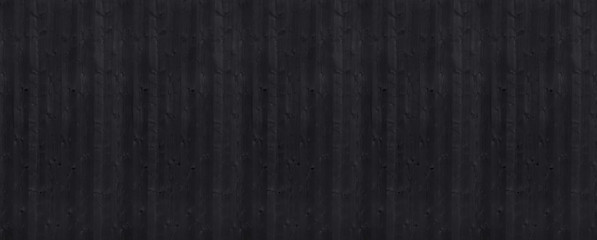 Long wide charred black wooden boards texture background. Horizontal panoramic view.
