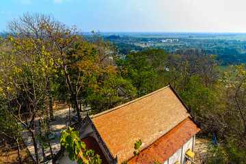 Aerial view from hilltop around with countryside green rice fields and blue sky background at Wat Khao Rup Chang or Temple of the Elephant Hill ,Phichit province, Thailand.