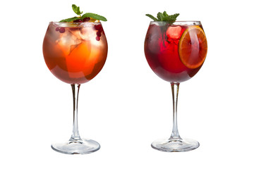 Two alcoholic or non-alcoholic cocktails with mint, fruits and berries on a white background. Cocktails in glass goblets.