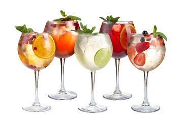 Refreshing cocktails with mint, fruits and berries on a white background. A variety of cocktails in glass goblets.