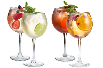 Refreshing alcoholic and non-alcoholic cocktails with mint, fruits and berries on a white background. A variety of cocktails in glass goblets.