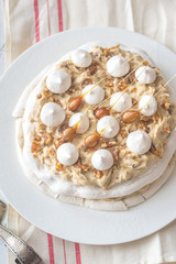 Pavlova cake with caramel and almonds