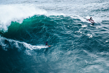 surfing big waves at Nazaré, Portugal