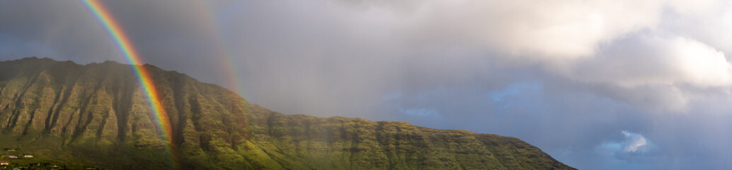 Panoramic view of Wai'anae mountains in Oahu with a double rainbow