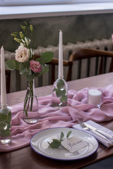 Exquisitely decorated wedding table with bouquet of roses