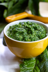Healthy vegetarian or vegan food, cooked green spinach with cream, ingredient for many dishes like pasta, ravioli or soup
