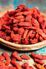 Healthy superfood, red dried goji chinese wolfberry berries, used in many snack foods and supplements, granola bars, yogurt, tea blends, fruit juice as whole berries or ground seeds, seed oil.