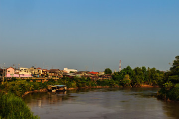 Obraz premium Landscape of Muang district, Phichit province, Thailand in summer with colorful houses and a blue sky on Nan river bank. Phichit is a province of Thailand and far 330 km from Bangkok.
