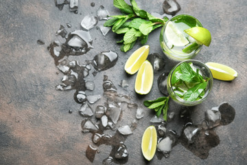 Mojito cocktail with ice, mint and lime on a dark background top view.