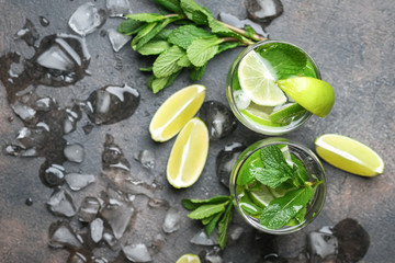 Mojito cocktail with ice, mint and lime on a dark background top view.