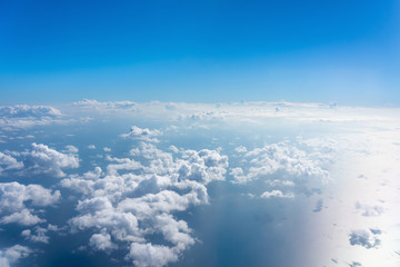 Sunny sky abstract background,Beautiful cloudscape on the atmosphere heaven.Scenic view sunrise over white fluffy clouds from the airplane window.Freedom,Nature,Backdrop Concept.Copy space for text.