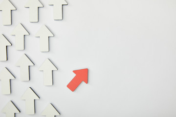 top view of red arrow near white pointers on grey background