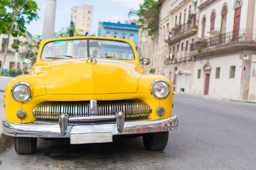 View of yellow classic vintage car in Old Havana, Cuba