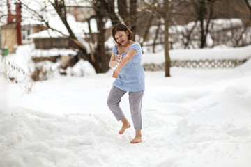 kid pounded with snow and playing barefoot in snow
