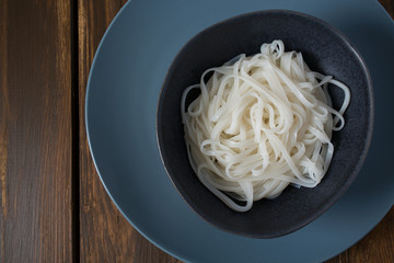 Rice noodles in a black bowl