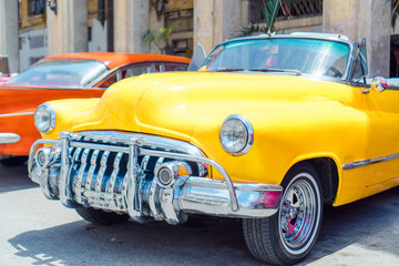 View of yellow classic vintage car in Old Havana, Cuba