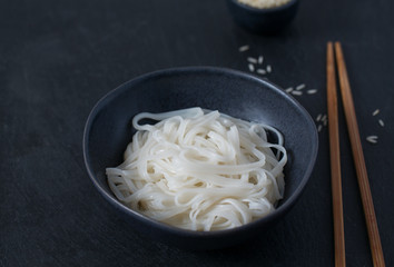 Rice noodles in a black bowl