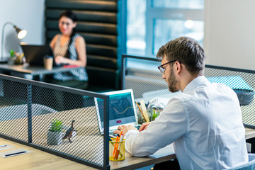 Fototapeta premium Serious brunette male working at his project
