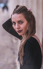 fashionable portrait of young beautiful woman in a European city on a sunny winter day