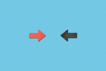 top view of opposite horizontal red and black arrows on blue background