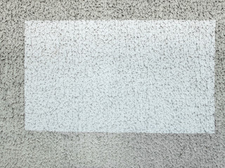 rectangle de peinture blanc sur un mur gris