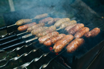 Homemade grilled sausages outdoors. Tasty food for barbecue party.