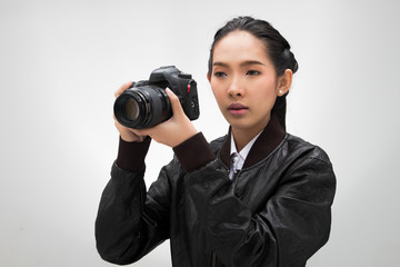 Photographer hold camera with lens point to shoot subject, wear normal dark black leater suit jacket. studio lighting white gradient grey background isolated, reporter journalist take photo celebrity