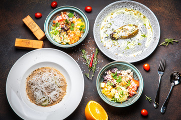 Fish and meat meals variety flat lay. Top view on buffet with assortment of healthy hearty food. Buffet, banquet, appetizer, restaurant menu concept