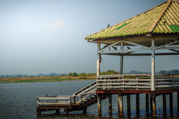 Beautiful lake view with the wooden pavilion at Bueng See Fai, the public park with lake at Muang district, Pichit province, Thailand.
