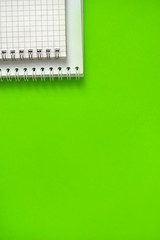 spiral notebook in a cage on a green background