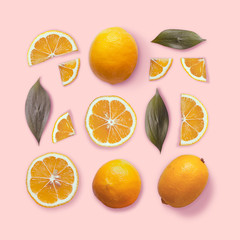 Composition of lemon and leaves in a square. Flat lay. Minimal summer concept. Lemon on a pink background. Top view.