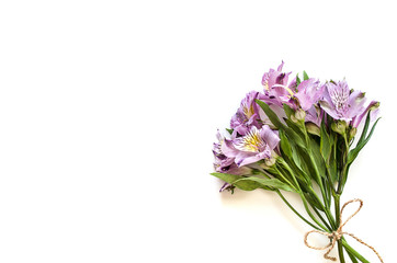Bouquet of flowers of yellow and purple Alstromeria on a white background. Flat lay, top view mockup. Copy space