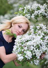 Beautiful girl on the background of spring bush