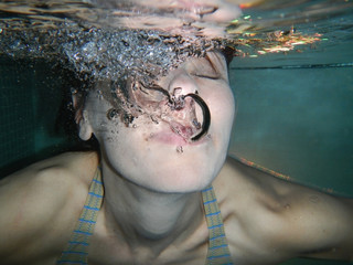 Woman Underwater with Bubbles.
