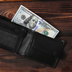 Dollars on a wooden background. Money in your wallet