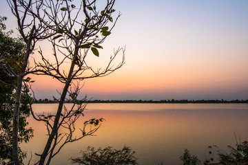 The sun sets on a large lake.9