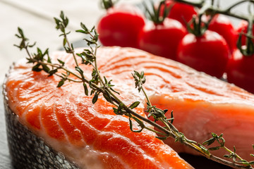 Branch of thyme placed on the slice of raw red fish