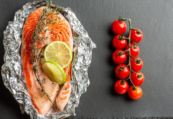 Top view of the raw fish and fresh cherry tomatoes © shevchukandrey