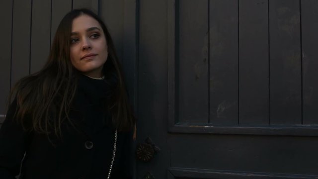 Beautiful disappointed girl waiting outside for boyfriend who is late for date