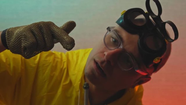 Crazy young professor with magnets in white coat. Thunder strikes from magnets around him