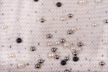Knitted texture with multi-colored pearls. Abstract Background
