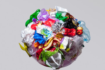 A globe of the earth with trash over white background, the concept of ecology problem and World...
