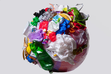 A globe of the earth with trash over white background, the concept of ecology problem and World...